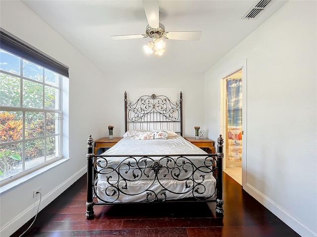 bedroom featuring multiple windows, ceiling fan, and dark hardwood / wood-style flooring