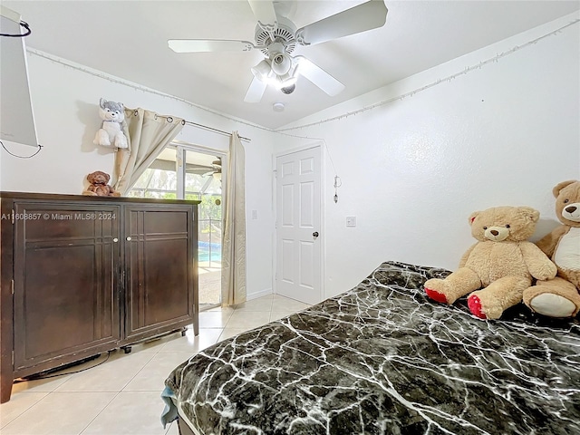 bedroom with ceiling fan, light tile flooring, and access to outside