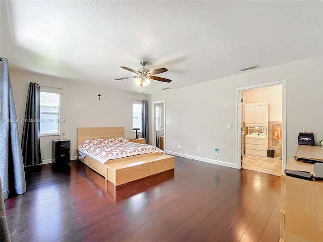 bedroom with connected bathroom, wood-type flooring, ceiling fan, and a textured ceiling