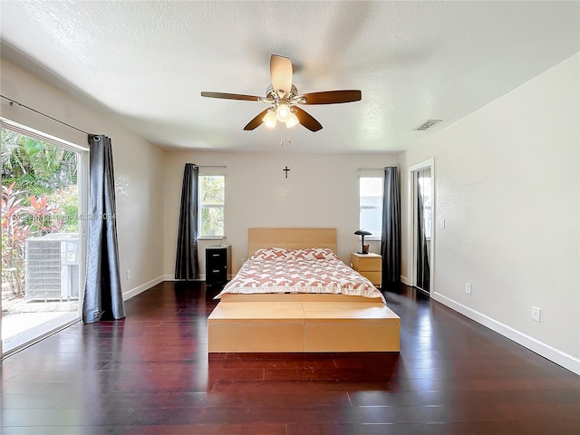 bedroom featuring access to outside, a textured ceiling, dark hardwood / wood-style floors, and ceiling fan