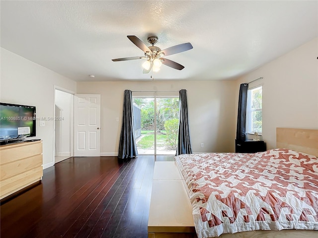 bedroom with dark wood-type flooring, ceiling fan, access to exterior, and multiple windows