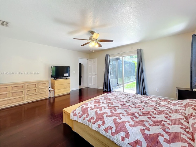 bedroom featuring a textured ceiling, access to exterior, ceiling fan, and dark hardwood / wood-style floors