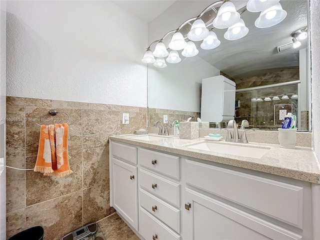 bathroom featuring tile walls, tile floors, double sink, and vanity with extensive cabinet space