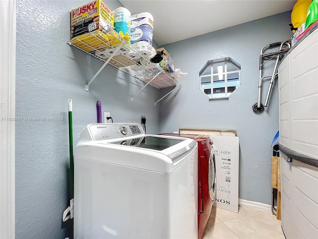 laundry room with independent washer and dryer, light tile flooring, and hookup for an electric dryer