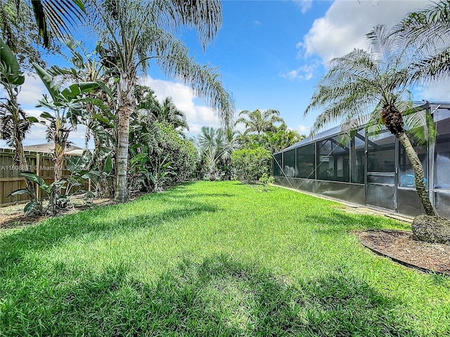 view of yard with glass enclosure