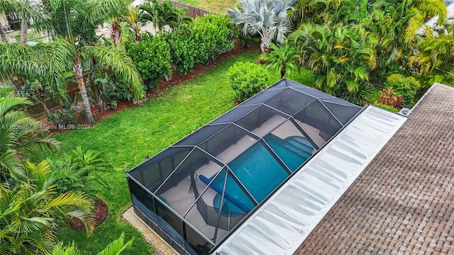 view of pool featuring a yard and a lanai