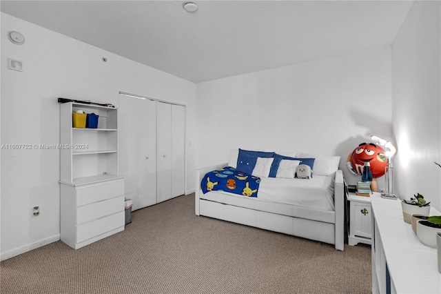 bedroom with light carpet and a closet