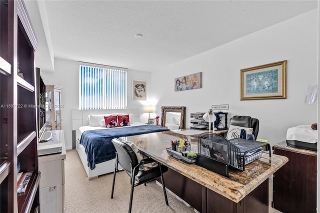 bedroom featuring light carpet and a textured ceiling