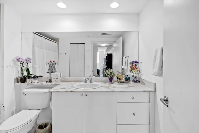 bathroom featuring vanity and toilet