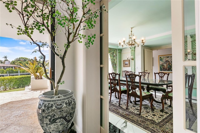 interior space featuring tile patterned floors, an inviting chandelier, and crown molding