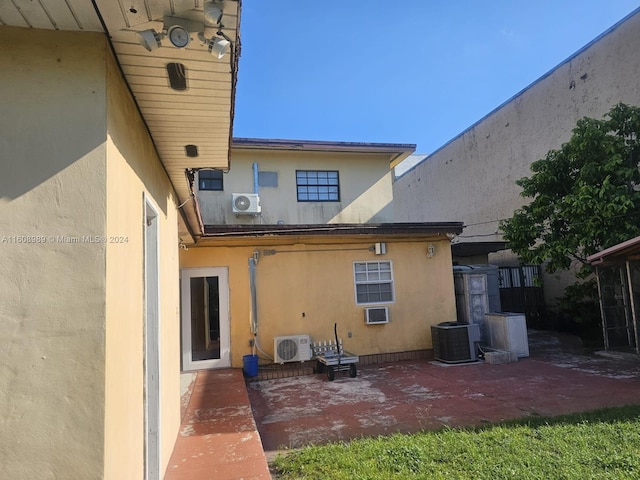 rear view of house with a patio and central air condition unit