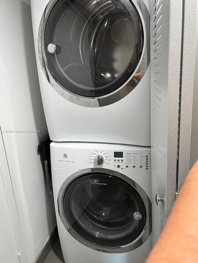 laundry room featuring stacked washing maching and dryer