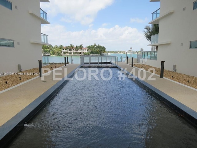 view of pool with a water view