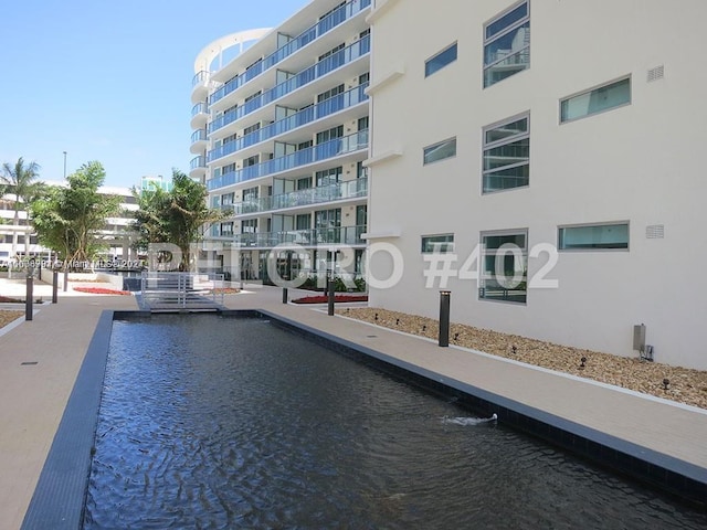 view of swimming pool featuring a water view