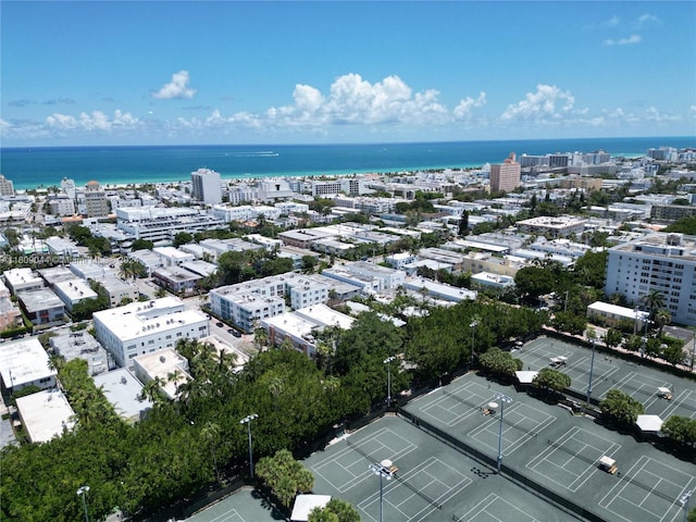 birds eye view of property with a water view and a city view