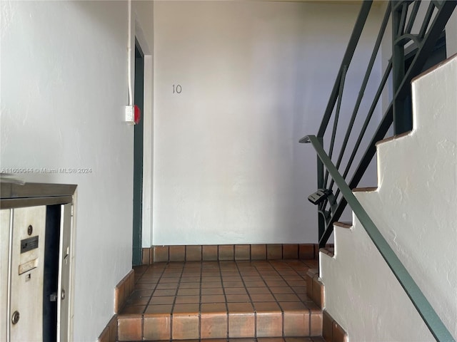 stairway with tile flooring