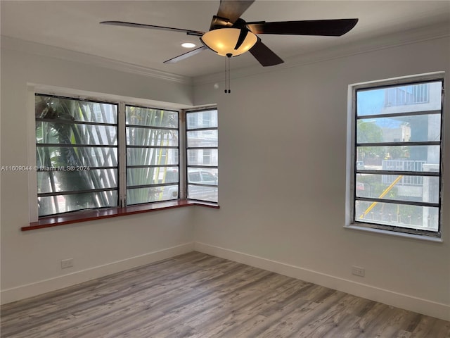 spare room with ceiling fan, hardwood / wood-style floors, and ornamental molding