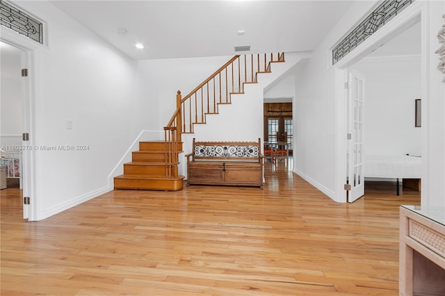 foyer entrance with french doors and light wood-type flooring