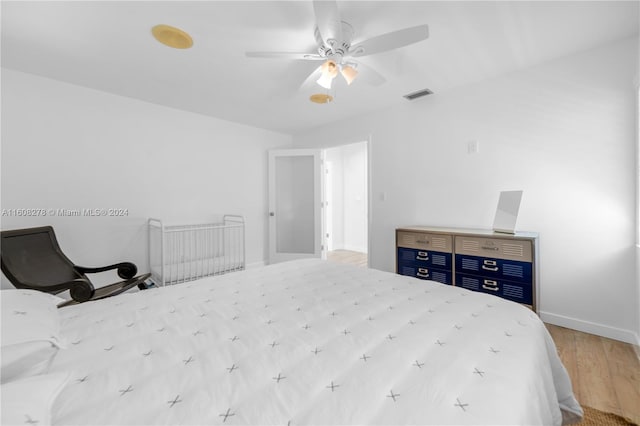 bedroom featuring light hardwood / wood-style floors and ceiling fan