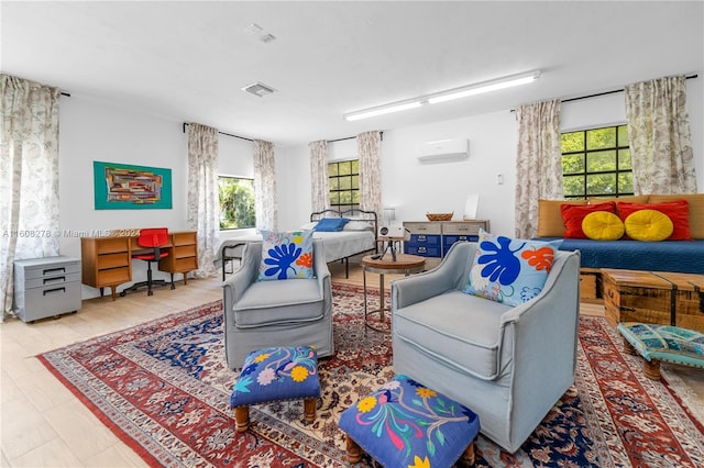 living room with an AC wall unit and plenty of natural light