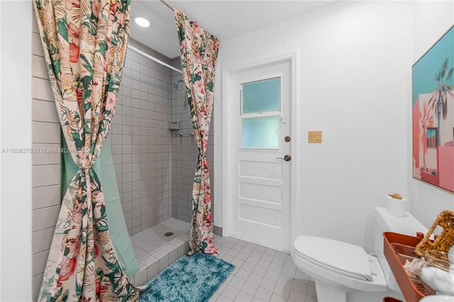 bathroom with toilet, tile patterned flooring, and walk in shower