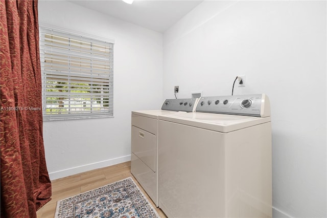 washroom featuring light hardwood / wood-style floors and washing machine and dryer