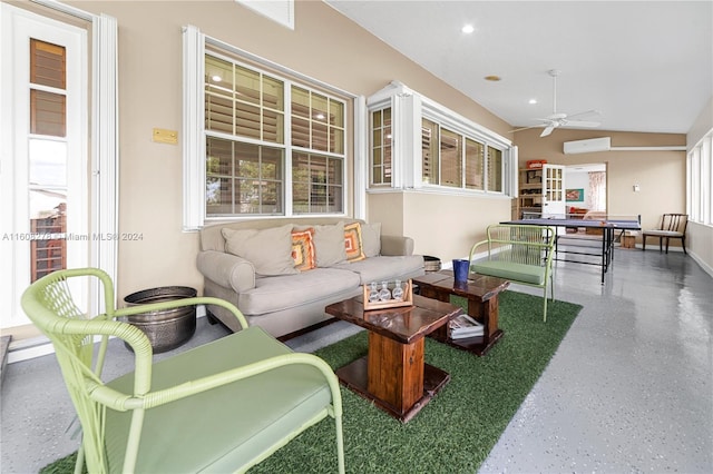 living room with a wall mounted AC, lofted ceiling, and ceiling fan