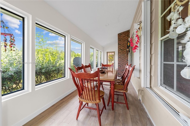 sunroom / solarium featuring lofted ceiling