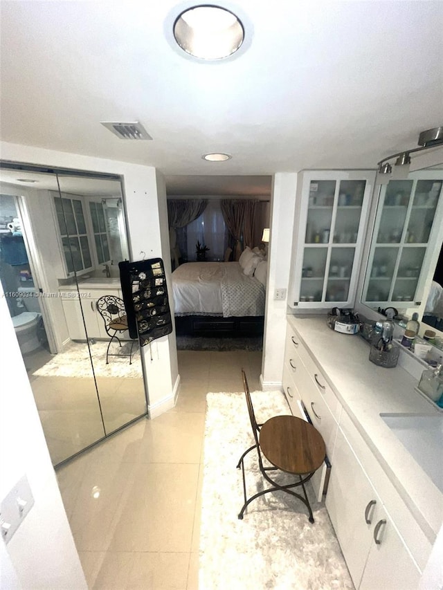 tiled bedroom with sink