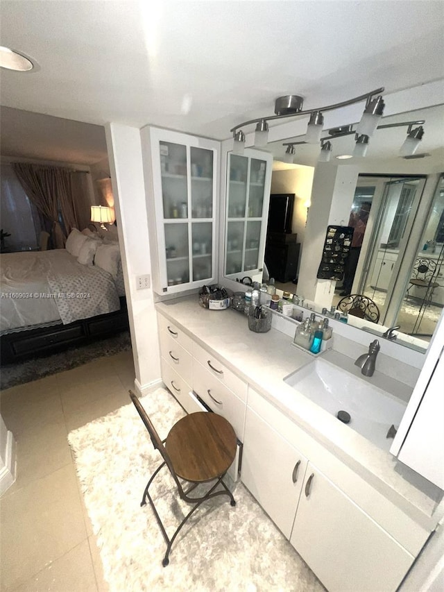 bathroom with tile patterned flooring and vanity