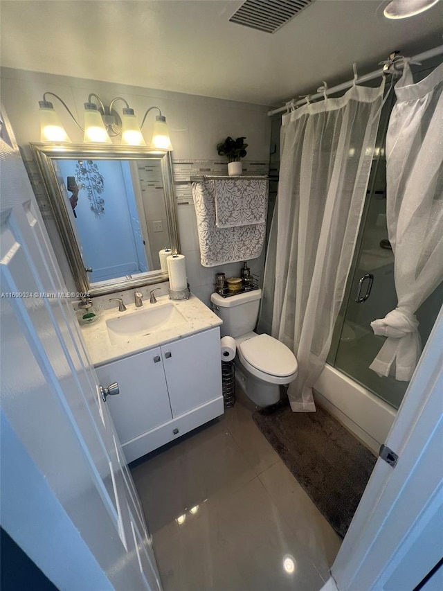 full bathroom with tile patterned floors, vanity, toilet, and shower / tub combo