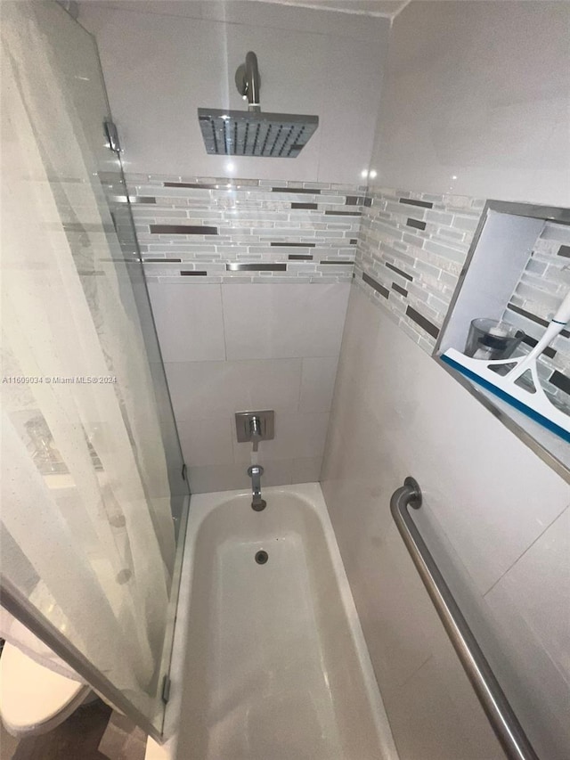 bathroom with bathing tub / shower combination