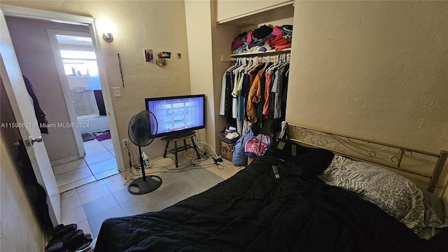 bedroom featuring a closet and light tile patterned floors