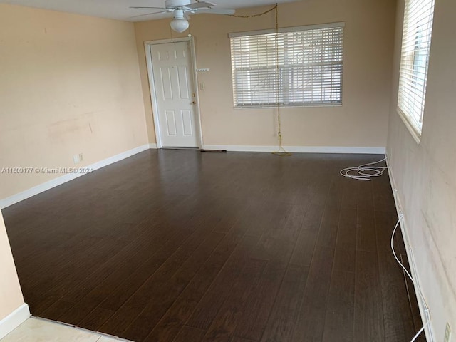 unfurnished room featuring ceiling fan and dark hardwood / wood-style floors