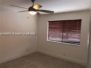 spare room featuring ceiling fan and hardwood / wood-style floors