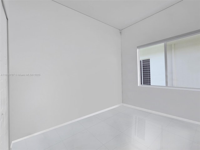 unfurnished room with light tile patterned floors