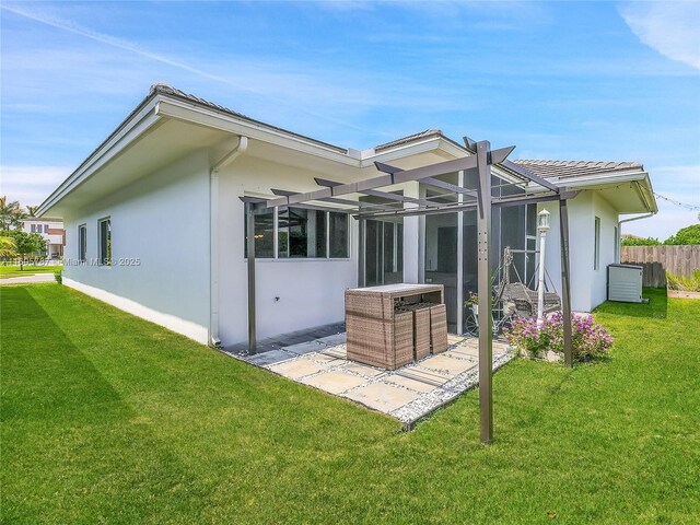 back of house featuring a yard and a patio