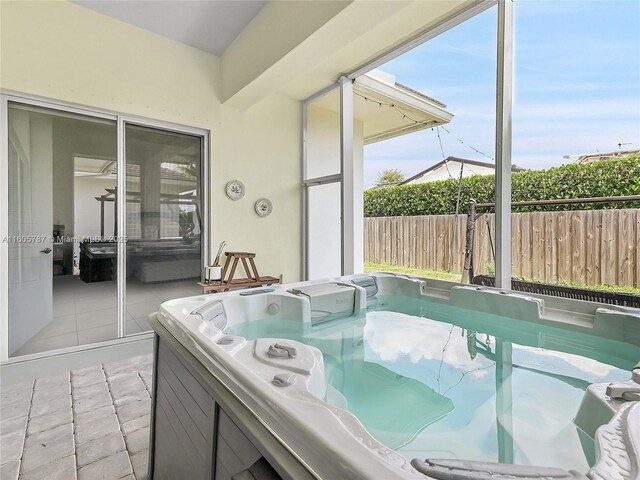 sunroom with a hot tub