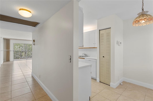 hall with sink and light tile patterned flooring