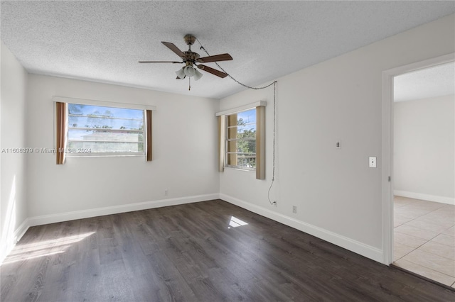 spare room with a textured ceiling, hardwood / wood-style flooring, and ceiling fan