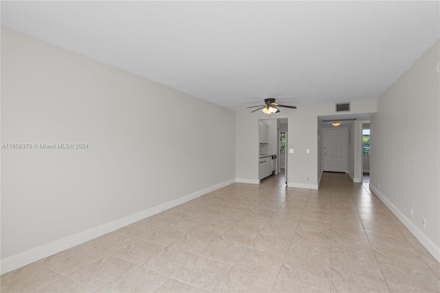 tiled empty room with ceiling fan