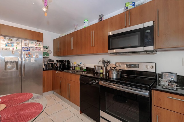 kitchen featuring light tile patterned flooring, stainless steel appliances, and sink