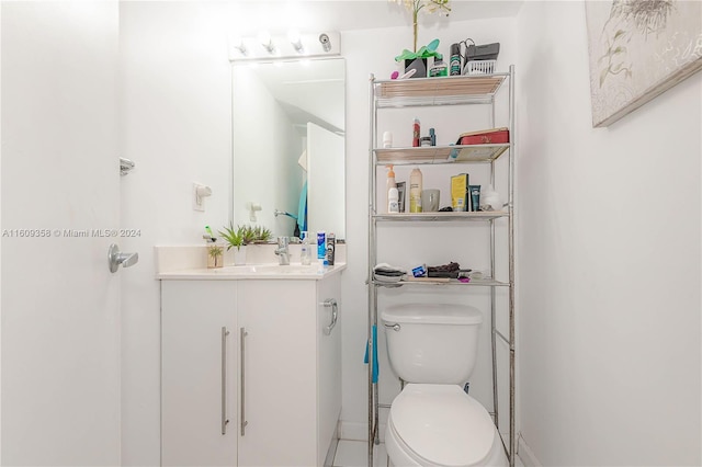 bathroom featuring toilet, vanity, and tile patterned floors