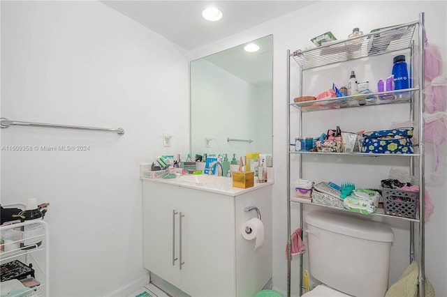 bathroom featuring toilet and vanity