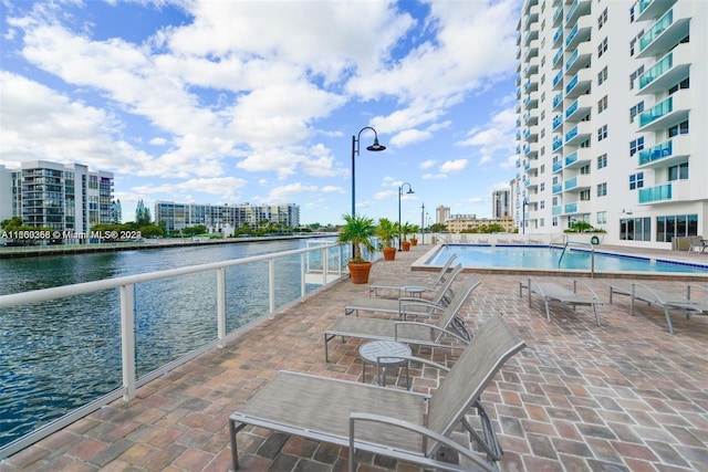 view of swimming pool with a water view