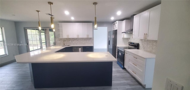 kitchen featuring hanging light fixtures, white cabinets, decorative backsplash, dark hardwood / wood-style floors, and black range with electric stovetop