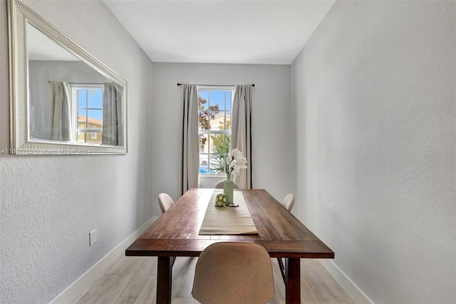 dining area with a healthy amount of sunlight and light wood-type flooring