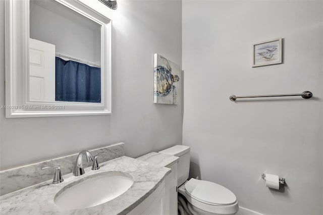 bathroom with toilet and vanity