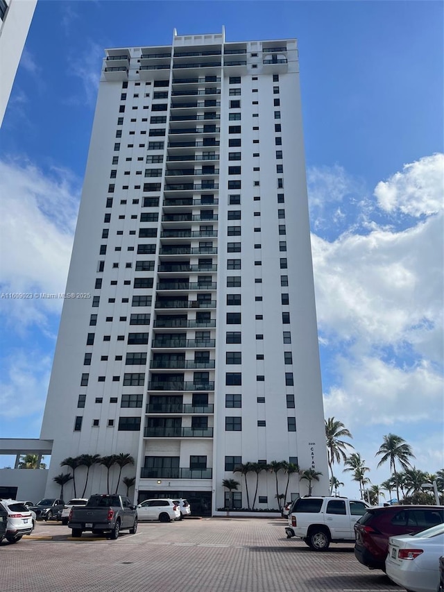 view of building exterior featuring uncovered parking