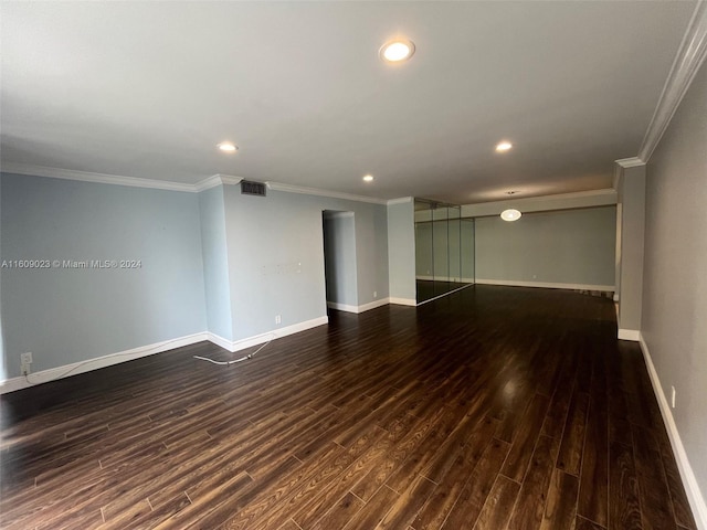 unfurnished room featuring dark hardwood / wood-style floors and crown molding